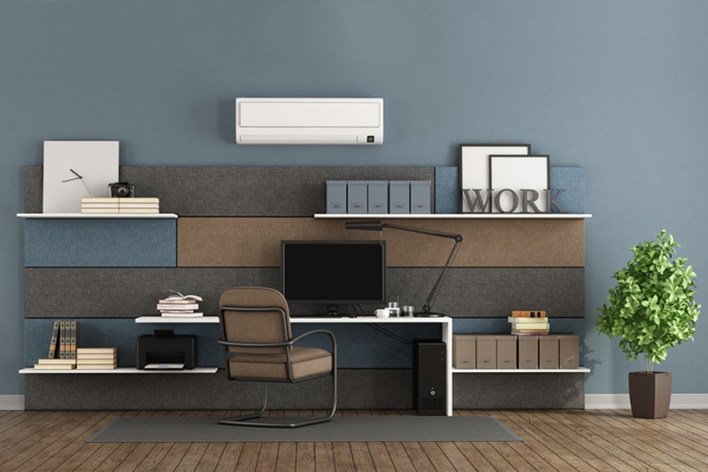 Blue and brown modern office with fabric paneling with shelves and desk.